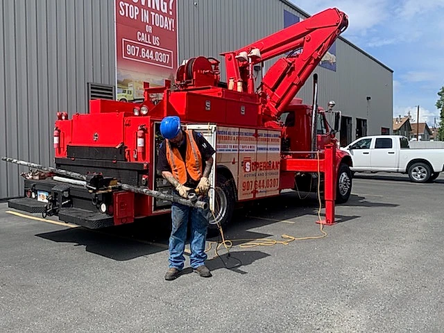 A Superman Moving mechanic servicing one of the company trucks
